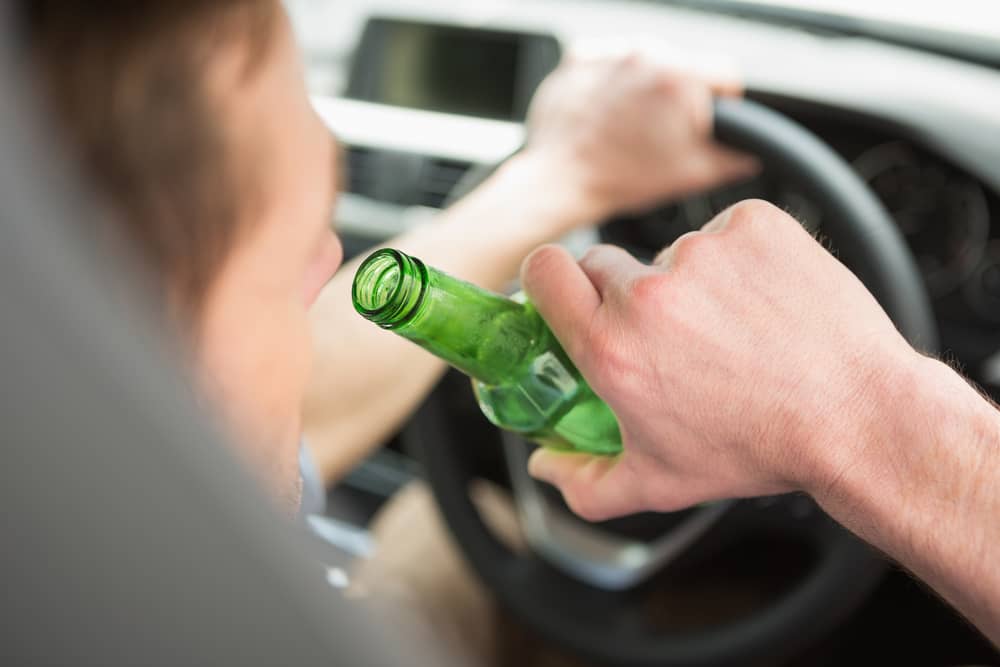 A Man Drinking While Driving Photo of a Man Drinking While Driving